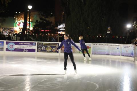 Two Team USA Figure Skating athletes skate on the ice rink in Acacia Park on the opening night celebrating in 2024.